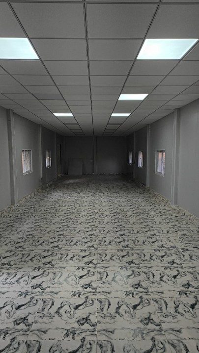 Dining hall interior — suspended modular ceiling with recessed LED panels.